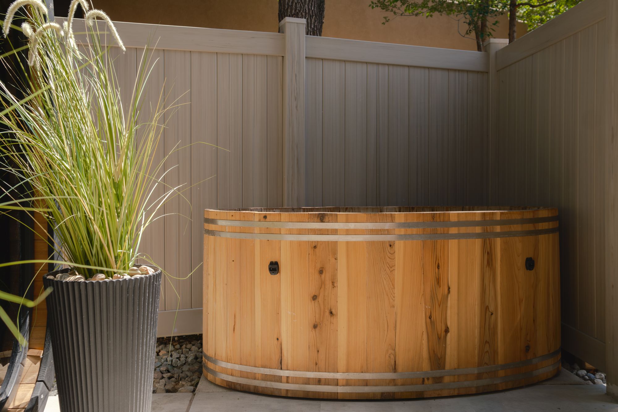 Private cedar cold plunge tub in the wellness courtyard at The Outrider Hotel