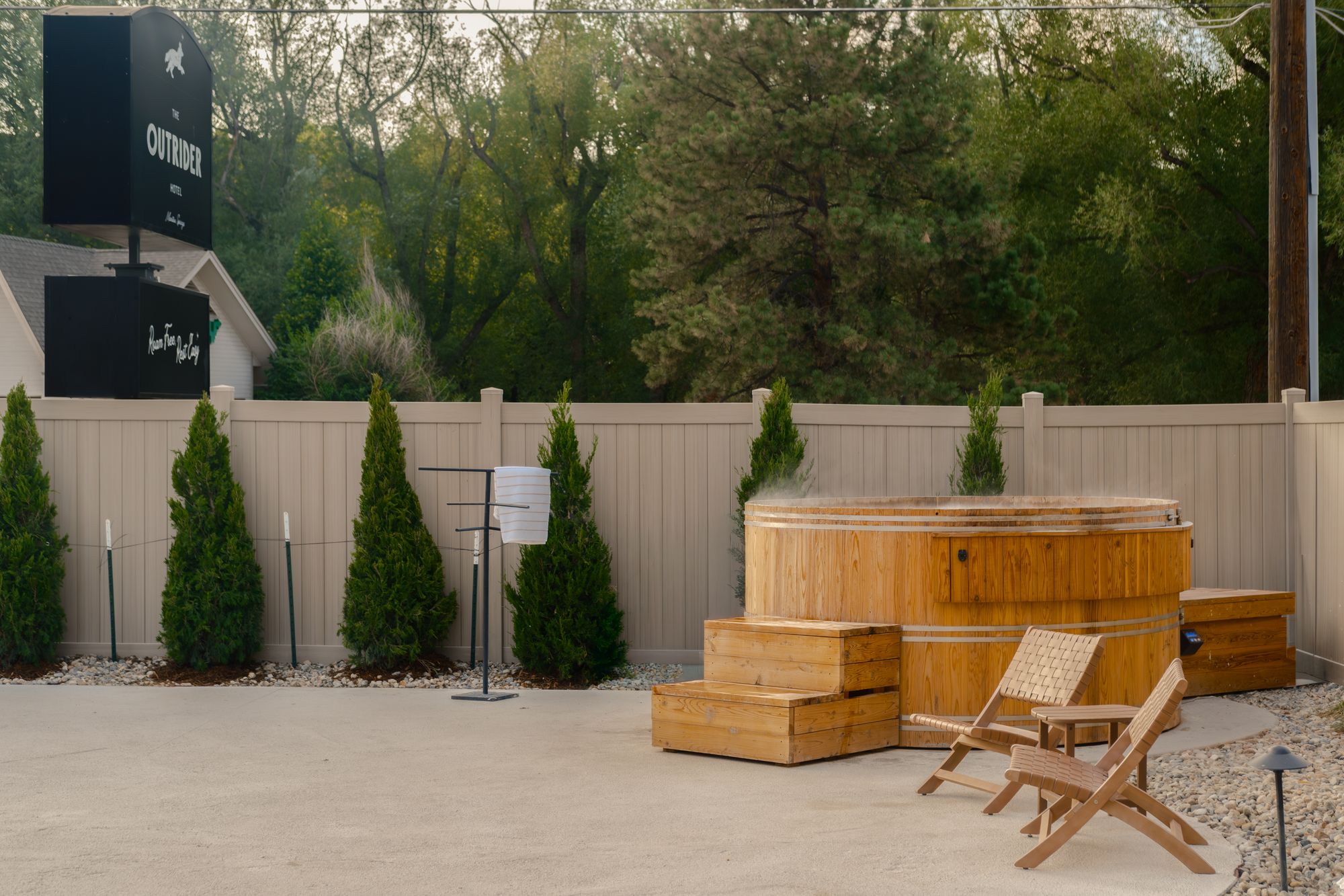 Cedar hot tub with wooden steps on the pool deck at The Outrider Hotel in Manitou Springs