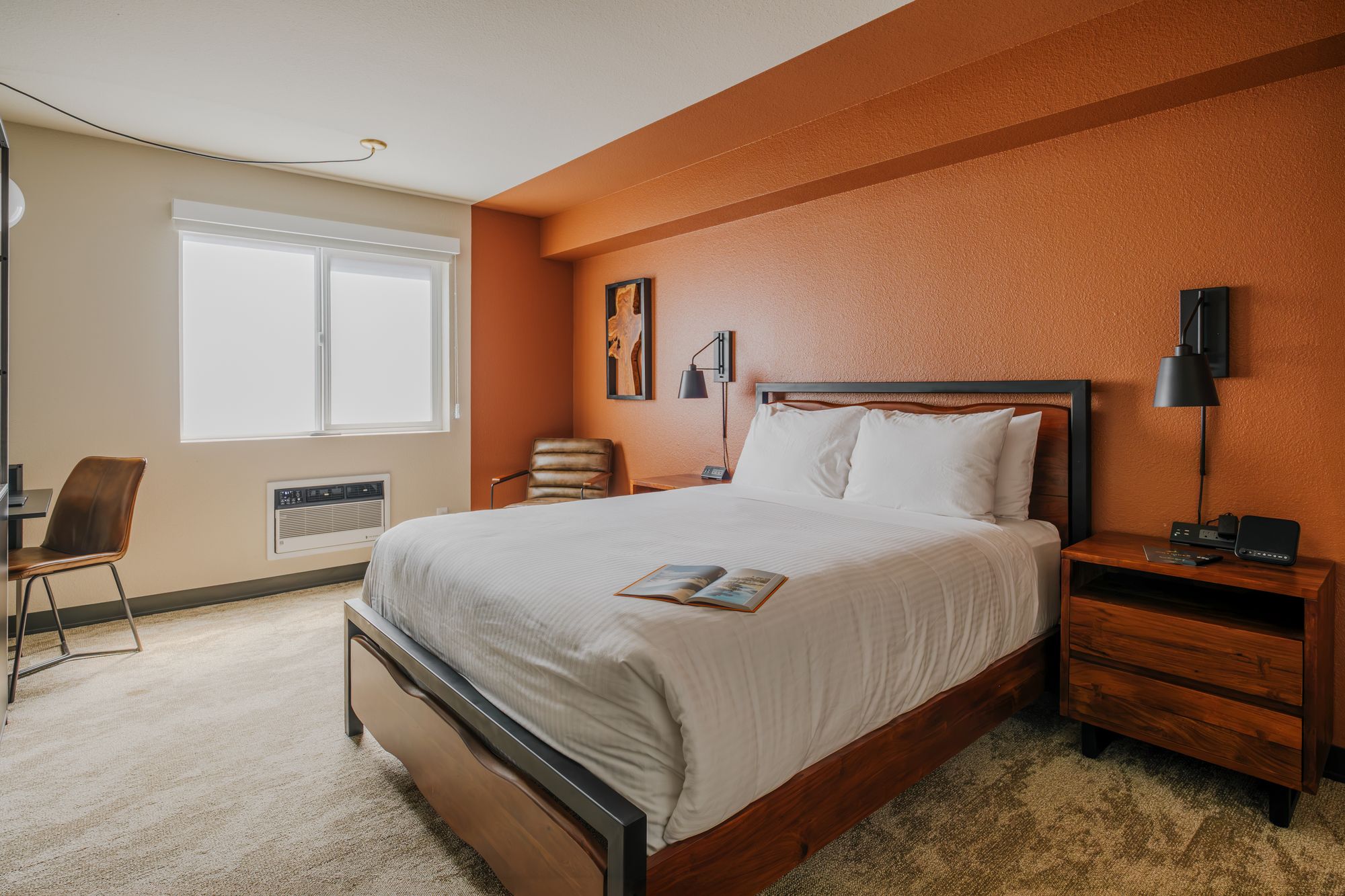 Classic Queen room with a queen bed and terracotta accent wall at The Outrider Hotel in Manitou Springs