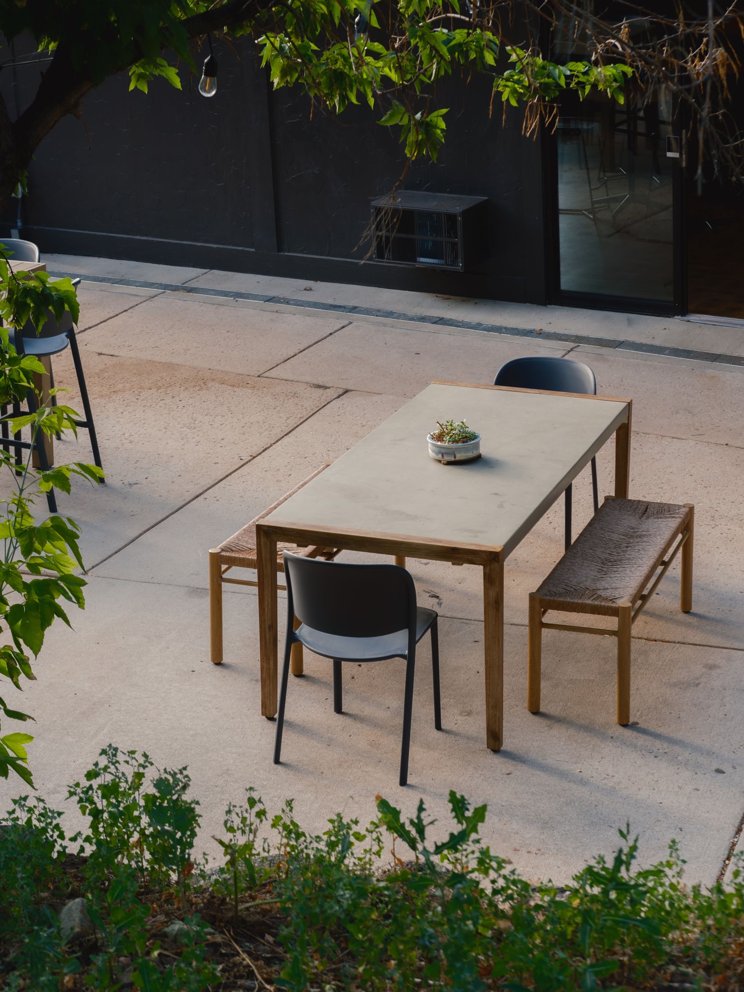 Shaded courtyard dining table with benches at The Outrider Hotel in Manitou Springs