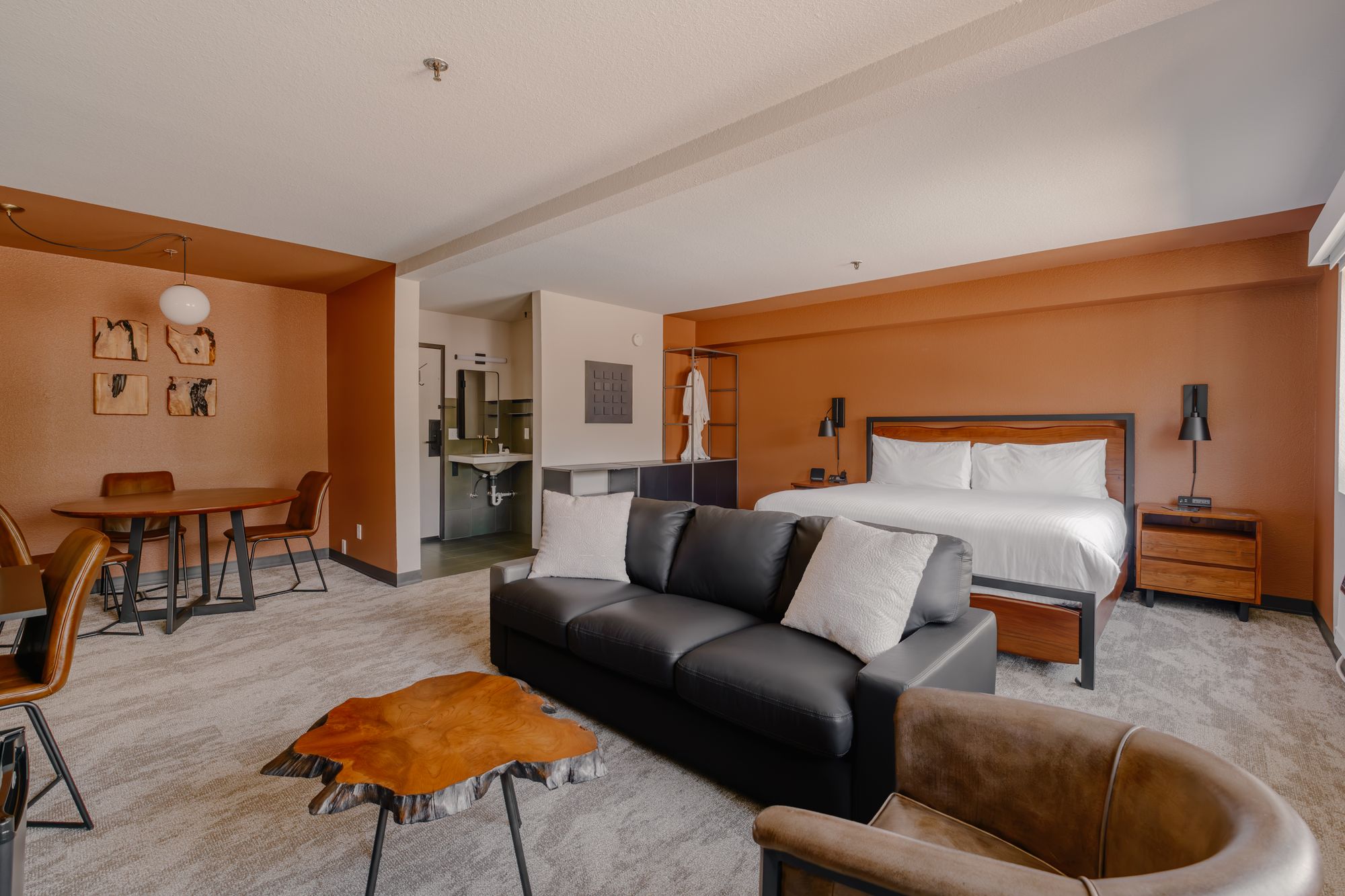 Grand King Suite at The Outrider Hotel in Manitou Springs with a king bed, living area and dining nook