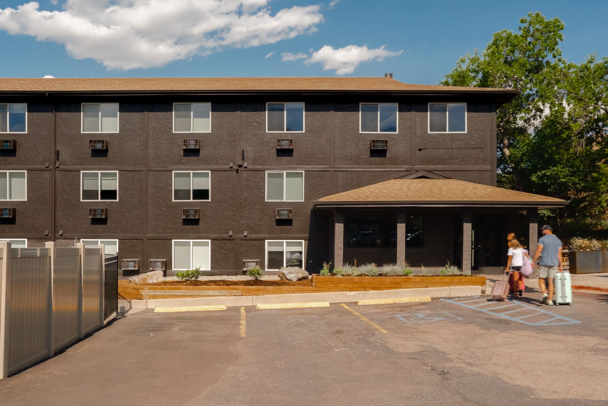 The Outrider Hotel exterior, entrance canopy, and guest parking on Manitou Avenue in Manitou Springs