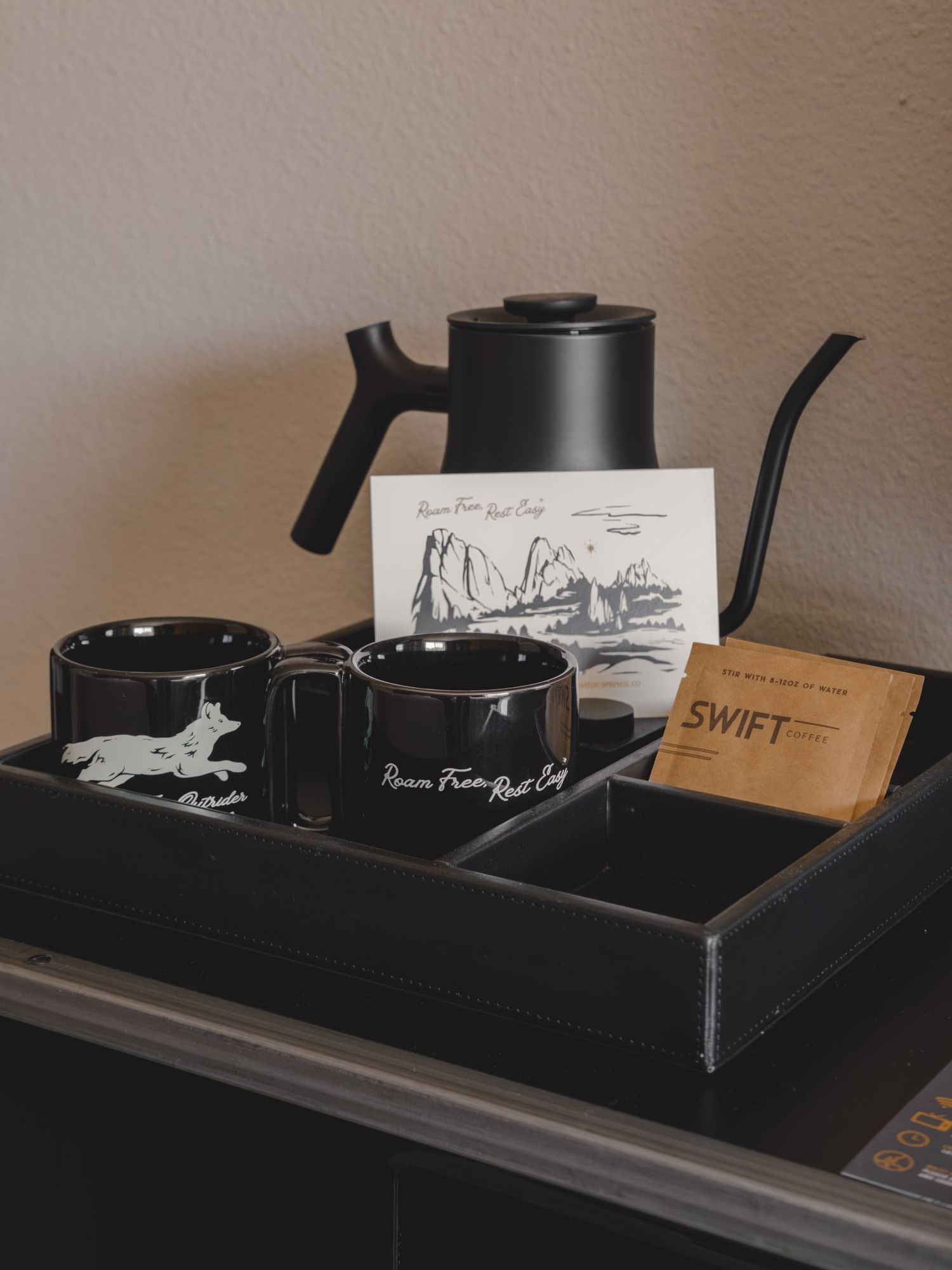 In-room pour-over coffee station with Outrider mugs and kettle at The Outrider Hotel in Manitou Springs