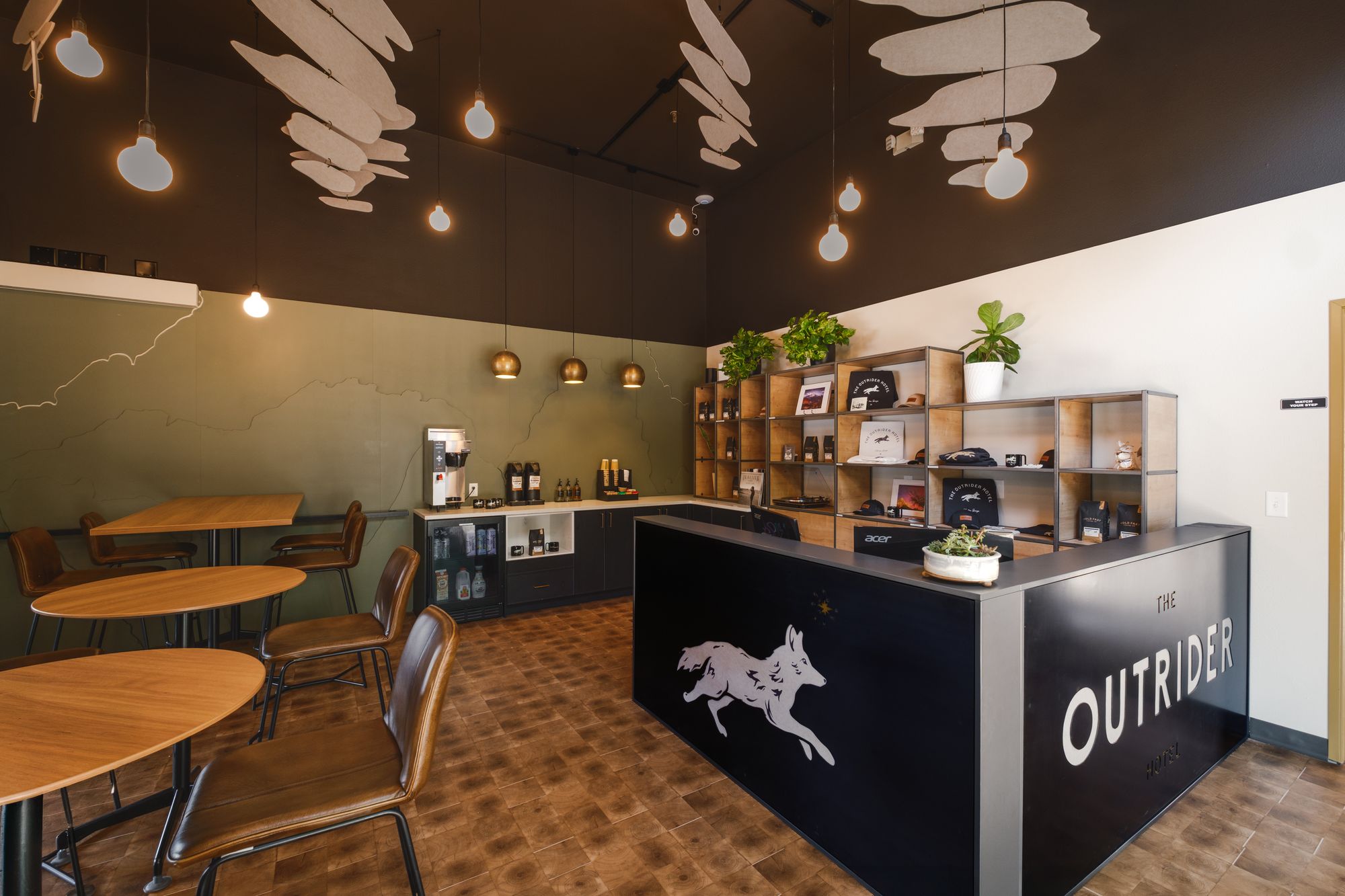 Lobby of The Outrider Hotel in Manitou Springs, Colorado, with the wolf-emblem front desk and breakfast bar
