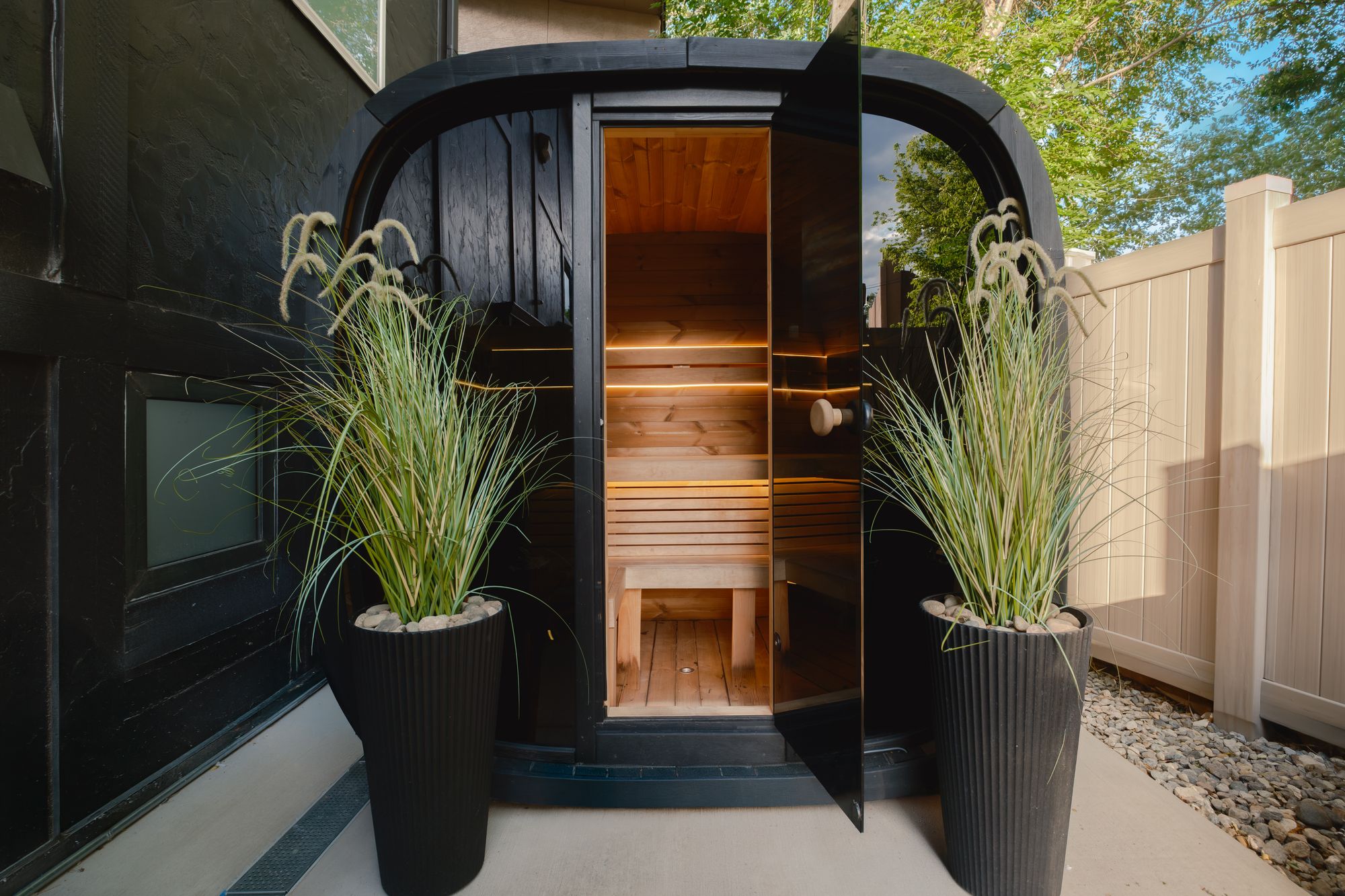 Cedar barrel sauna with its door open at The Outrider Hotel in Manitou Springs