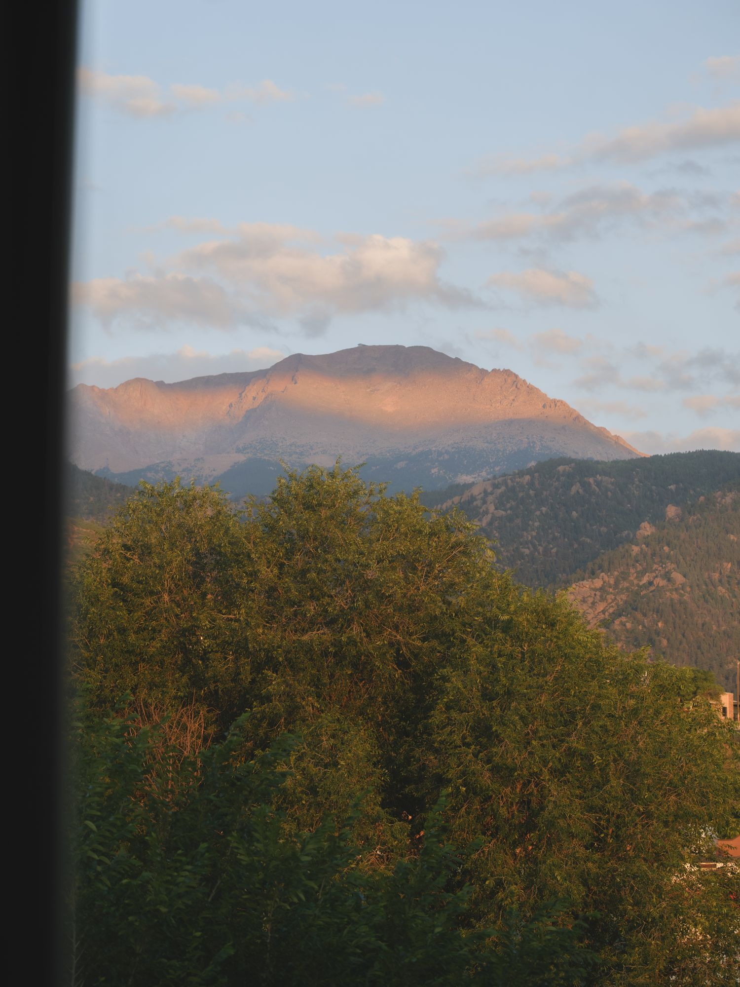 Evening alpenglow on Pikes Peak viewed from The Outrider Hotel in Manitou Springs