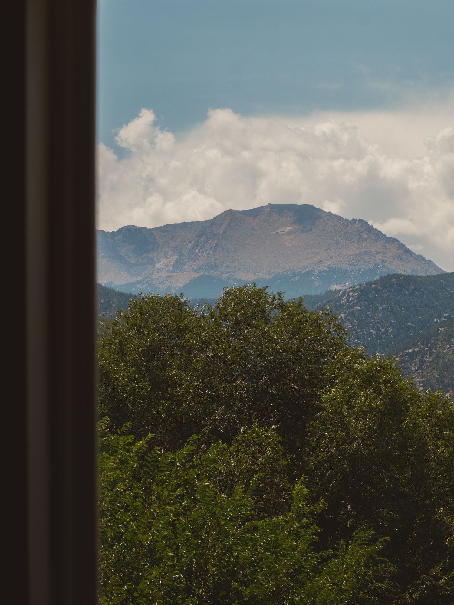 Pikes Peak seen from a guest room window at The Outrider Hotel in Manitou Springs, Colorado